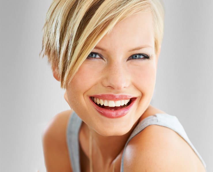 Woman with short blonde hair smiling big | Medical Aesthetics and Wellness of Modesto